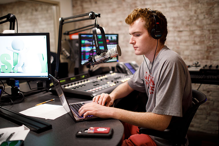 Students broadcasting in the WIUX studio