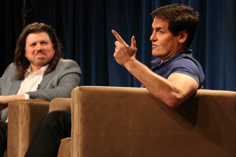 Mark Cuban sits next to Galen Clavio on stage speaking to students.