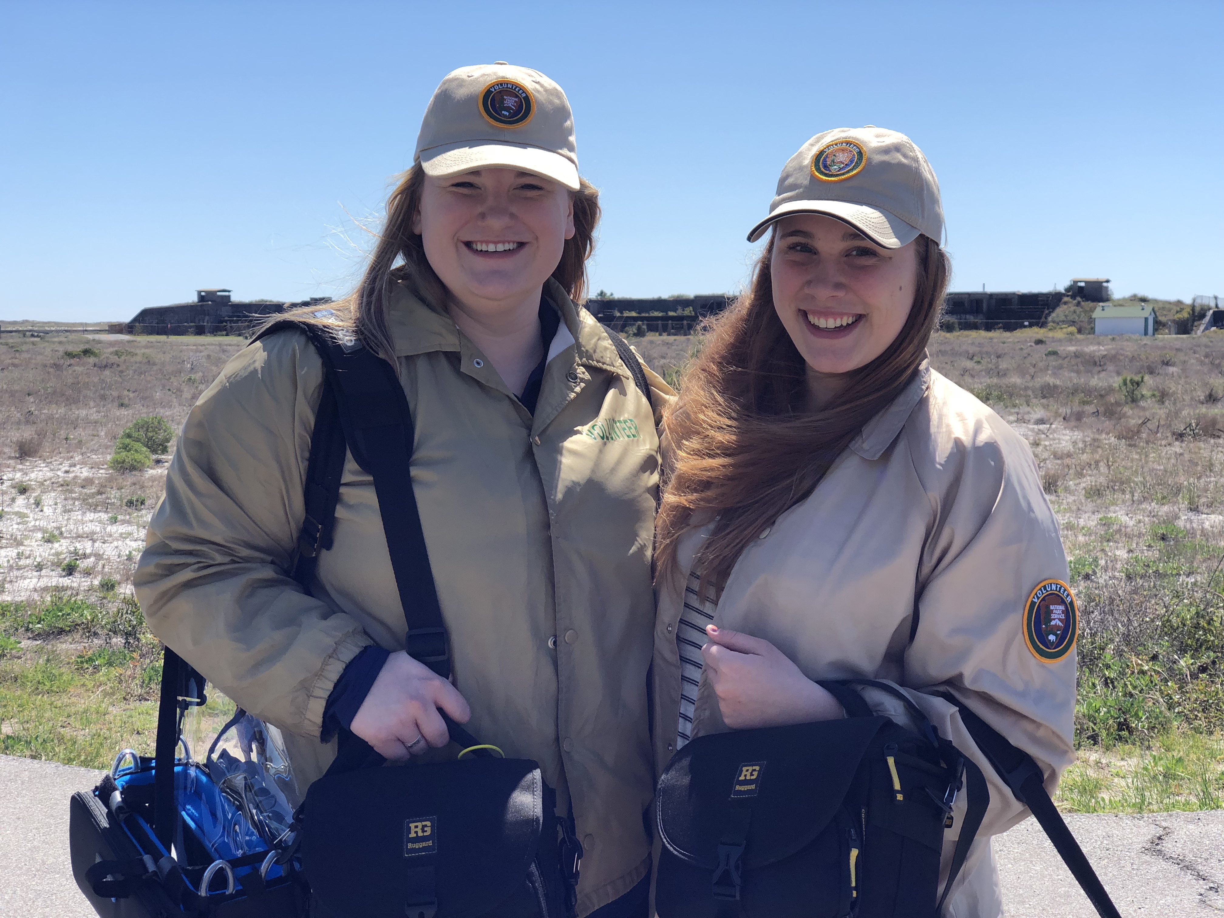 Two students smile wearing NPS Volunteer gear in Gulf Islands.