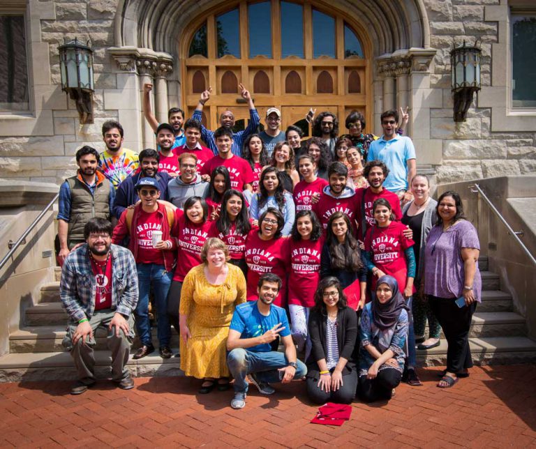Students wearing spiritwear smile for a group photo in front of Franklin Hall.