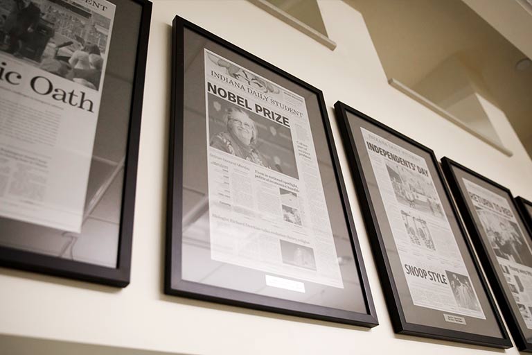 Framed IDS articles hang on a wall