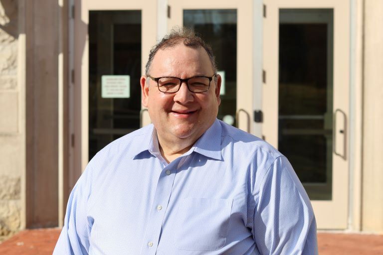 Headshot of Terry Rubin standing outside.